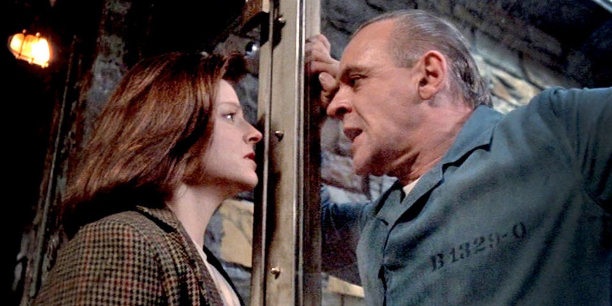 Jodie Foster looking at Anthony Hopkins behind the glass of his cell in The Silence of the Lambs
