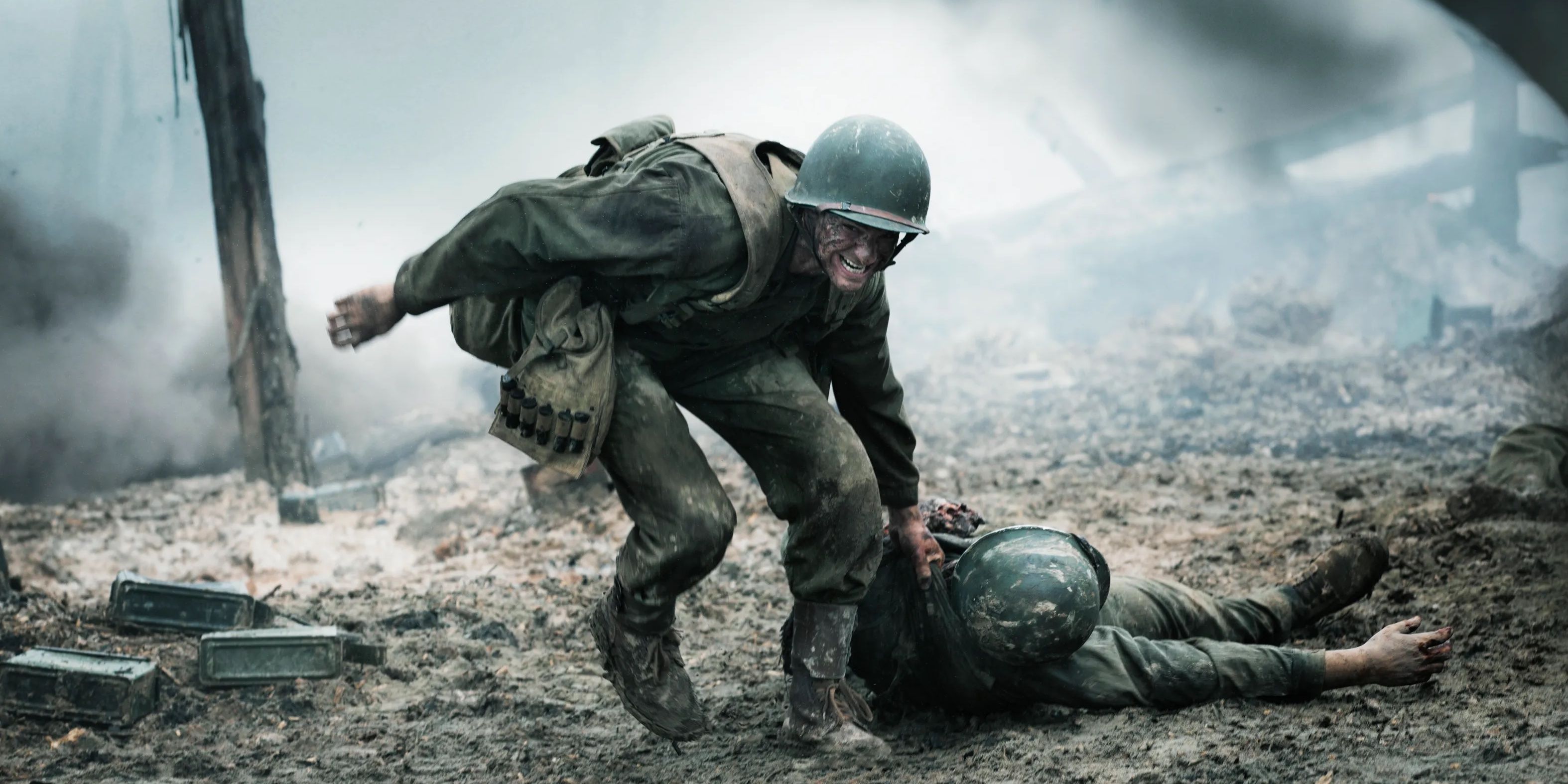 Andrew Garfield as Desmond Doss rescuing a fallen soldier from battlefield in Hacksaw Ridge.