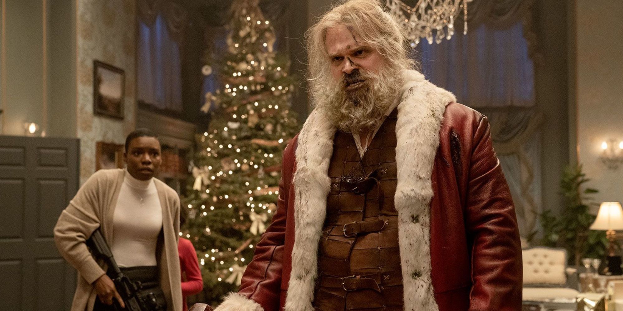 Un Papá Noel con la nariz ensangrentada sosteniendo un mazo y un mercenario armado mirando con miedo.