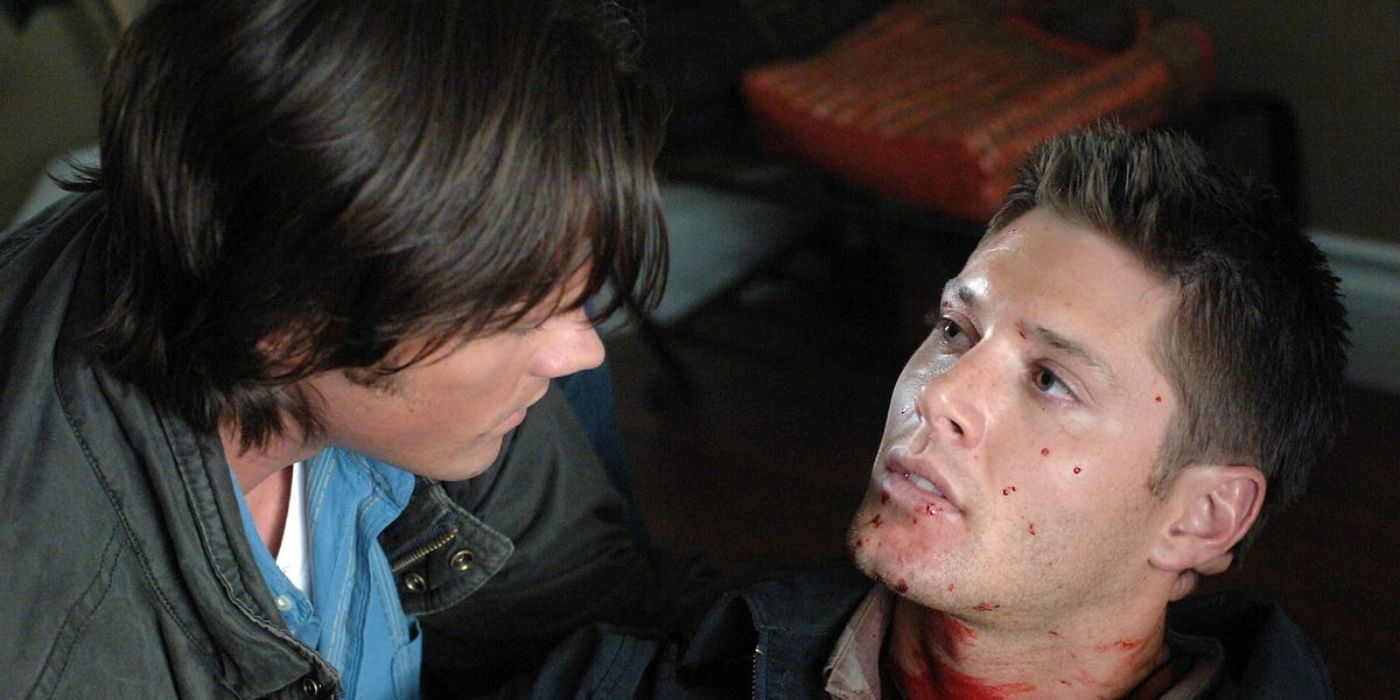 Sam cradles Dean's bloodied, dying body following an attack from the hellhounds.