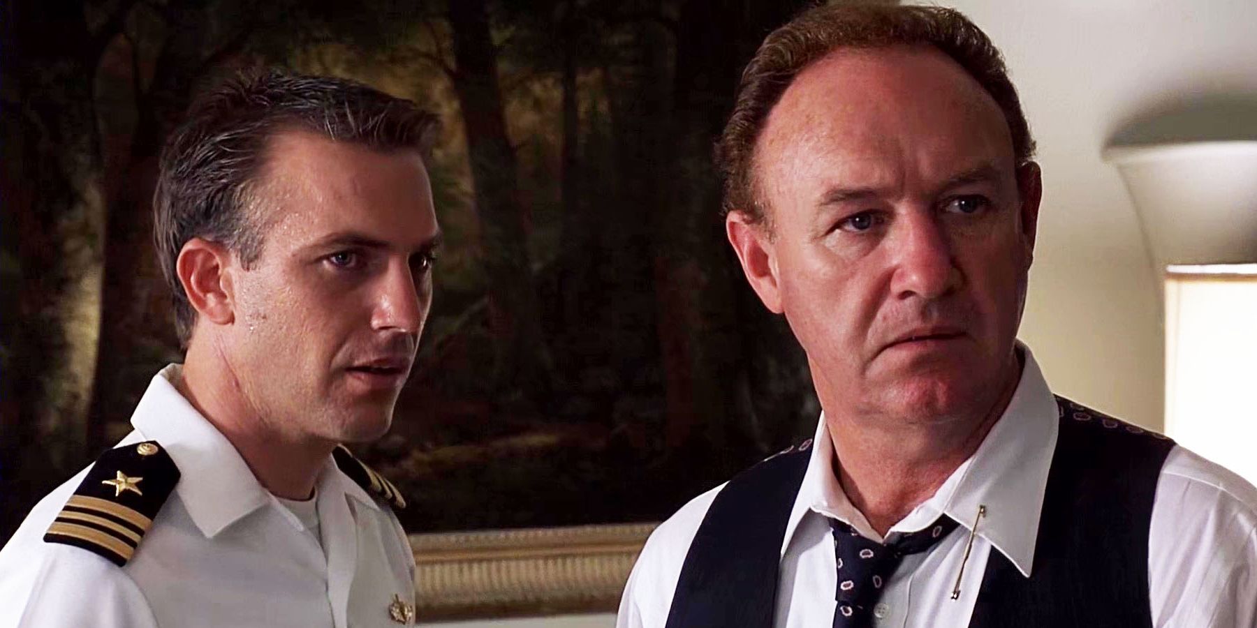 Kevin Costner and Gene Hackman as Tom Farrell and David Brice, in uniform and looking concerned at something offscreen in 'No Way Out'
