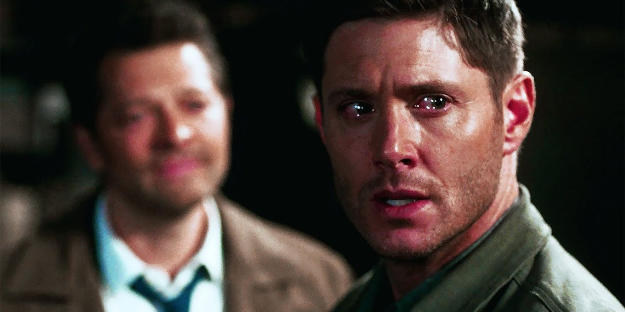 Dean (Jensen Ackles) crying while Castiel (Misha Collins) stands behind him in Supernatural