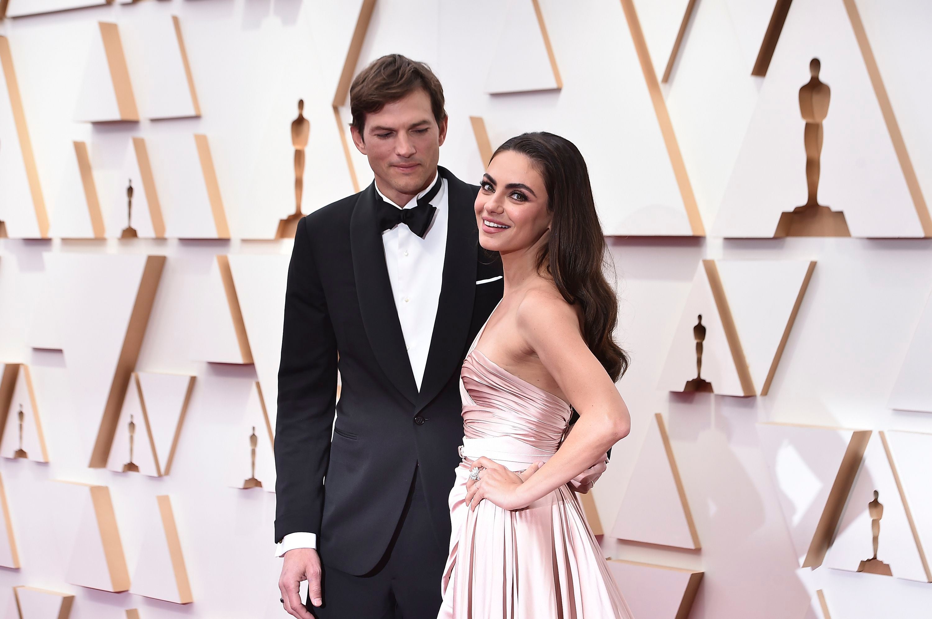 FILE - Ashton Kutcher, left, and Mila Kunis arrive at the Oscars, Sunday, March 27, 2022, at the Dolby Theater in Los Angeles.  (Photo by Jordan Strauss/Invision/AP, File)